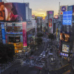 
              FILE - People walk across the famed Shibuya scramble crossing as the sun sets behind the skyscraper Monday, Oct. 11, 2021, in Tokyo. The Japanese economy contracted in the first quarter, but at a smaller rate than earlier estimated, the government said Wednesday, June 8, 2022. The world’s third-largest economy contracted at an annual rate of 0.5%, according to Cabinet Office data. That was smaller than the 1.0% contraction in the preliminary estimate for Japan’s real gross domestic product, or GDP, released in May. (AP Photo/Kiichiro Sato, File)
            