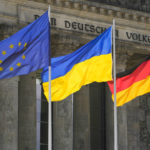 
              The Ukrainian national flag waves betwen the Europa fag, left, and the German national flag, right, in front of the Reichstag building during a debate at the German parliament Bundestag in Berlin, Germany, Wednesday, June 1, 2022. The inscription reads: 'The German People'. (AP Photo/Markus Schreiber)
            
