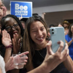 
              CORRECTS MONTH TO JUNE INSTEAD OF JANUARY - Georgia state Rep. Bee Nguyen FaceTimes with her parents while celebrating Tuesday, June 21, 2022, in Atlanta, after winning a runoff election to be the Democratic candidate for Georgia Secretary of State. (AP Photo/Ben Gray)
            