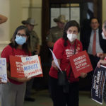 
              Women with Moms Demand Action gather outside the Texas Senate Chamber as the second day of a hearing begins, Wednesday, June 22, 2022, in Austin, Texas. The hearing is in response to the recent school shooting in Uvalde, Texas, where two teachers and 19 students were killed. (AP Photo/Eric Gay)
            