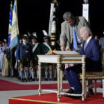 
              President Joe Biden signs a guest book after arriving as Bavarian Prime Minister Markus Soeder stands next to him at Munich International Airport in Munich, Germany, Saturday, June 25, 2022. Biden is in Germany to attend a Group of Seven summit of leaders of the world's major industrialized nations. (AP Photo/Susan Walsh)
            