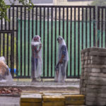 
              People stand covered in plastic sheets as it rains in New Delhi Thursday, June 30, 2025. India's monsoon season runs from June to September. (AP Photo/Rajesh Kumar Singh)
            