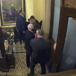 
              In this image from video, a security video shows Vice President Mike Pence being evacuated from near the Senate chamber as rioters breach the Capitol, on Jan. 6, 2021, at the Capitol in Washington. Pence won’t be testifying at Thursday’s Jan. 6 committee hearing. But he will be in the spotlight as the group turns its focus to former President Donald Trump’s desperate attempts to persuade Pence to overturn the results of the 2020 presidential election. (Senate Television via AP)
            
