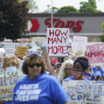 
              Protesters march down Jefferson Avenue past the site of the Tops massacre during a March for Our Lives rally in support of gun control, Saturday, June 11, 2022, in Buffalo, N.Y. (Derek Gee/The Buffalo News via AP)
            