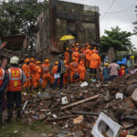 
              Rescuers look for survivors in the debris of a four-story residential building that collapsed in Mumbai, India, Tuesday, June 28, 2022. At least three people died and more were injured after the building collapsed late Monday night. (AP Photo/Rafiq Maqbool)
            