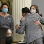 
              California Assembly Speaker Anthony Rendon, center, hugs state Sen. Nancy Skinner, D-Berkeley, right after the Assembly approved a measure to put a constitutional amendment on the November ballot, co-authored by Rendon and state Sen. Pro Tempore Toni Atkins, left, that would guarantee the right to an abortion and contraceptives,  at the Capitol in Sacramento, Calif., Monday, June 27, 2022. The vote comes three days after the U.S. Supreme Court overruled Roe v. Wade. (AP Photo/Rich Pedroncelli)
            