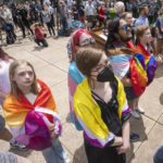 
              People watch the Rainbow Pride flag raising Wednesday, June 1, 2022 at the Capitol in Madison, Wis. The symbol of lesbian, gay, bisexual and transgender pride will be flown over the Capitol's East Wing in recognition of LGBTQ Pride Month, which runs until the end of June. In June 2019, Gov. Tony Evers issued an executive order to raise the pride flag above the state Capitol for the first time in Wisconsin history. This is the fourth year the flag has flown below the U.S. and state flags on the east-wing flagpole. (Mark Hoffman/Milwaukee Journal-Sentinel via AP)
            