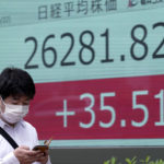 
              A man wearing a protective mask walks in front of an electronic stock board showing Japan's Nikkei 225 index at a securities firm Wednesday, June 22, 2022, in Tokyo. Asian shares were mostly lower Wednesday as markets shrugged off a Wall Street rally and awaited congressional testimony by Federal Reserve Chair Jerome Powell. (AP Photo/Eugene Hoshiko)
            