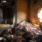 
              FILE - Scattered grain sits inside a warehouse damaged by Russian attacks in Cherkaska Lozova, outskirts of Kharkiv, eastern Ukraine, Saturday, May 28, 2022. Russian hostilities in Ukraine are preventing grain from leaving the “breadbasket of the world" and making food more expensive across the globe, raising the specter of shortages, hunger and political instability in developing countries. Together, Russia and Ukraine export nearly a third of the world’s wheat and barley, more than half its sunflower oil and are big suppliers of corn. (AP Photo/Bernat Armangue, File)
            
