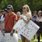 
              Community members gather to protest the U.S. Supreme Court's overturning of Roe v. Wade and Kentucky's trigger law to ban abortion, at Circus Square Park in Bowling Green, Ky., on Saturday, June 25, 2022. (Grace Ramey/Daily News via AP)
            