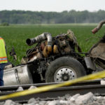 
              A worker looks over a dump truck that collided with an Amtrak train, causing it to derail Monday, June 27, 2022, near Mendon, Mo. (AP Photo/Charlie Riedel)
            