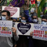 
              Indian Muslims hold placards demanding the arrest of Nupur Sharma, a spokesperson of governing Hindu nationalist party as they react to the derogatory references to Islam and the Prophet Muhammad made by her during a protest in Mumbai, India, Monday, June 6, 2022. At least five Arab nations have lodged official protests against India, and Pakistan and Afghanistan also reacted strongly Monday to the comments made by two prominent spokespeople from Prime Minister Narendra Modi's Bharatiya Janata Party. (AP Photo/Rafiq Maqbool)
            