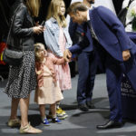
              France's President Emmanuel Macron greets a child as he arrives to vote in the first round of French parliamentary election at a polling station in Le Touquet, northern France, Sunday June 12, 2022. French voters are choosing lawmakers in a parliamentary election Sunday as President Emmanuel Macron seeks to secure his majority while under growing threat from a leftist coalition. (Ludovic Marin, Pool via AP)
            