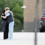 
              Two people hug as they are reunited at Memorial High School after being evacuated from the scene of a shooting at the Natalie Medical Building Wednesday, June 1, 2022. in Tulsa, Okla. Multiple people were shot at a Tulsa medical building on a hospital campus Wednesday. (Ian Maule/Tulsa World via AP)
            