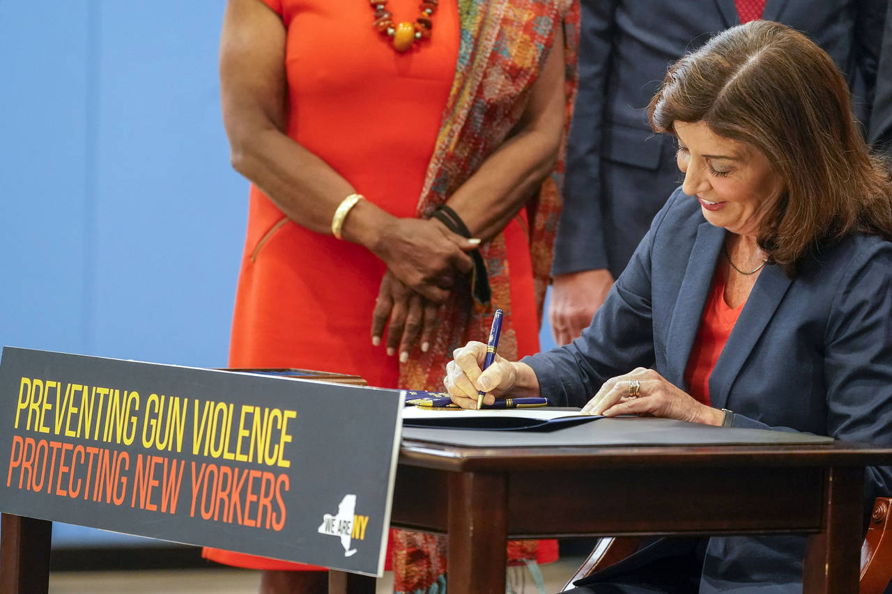 FILE — New York Gov. Kathy Hochul signs a package of bills to strengthen gun laws, June 6, 2022, ...