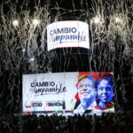 
              Confetti explode over screen showing photos of presidential candidate Gustavo Petro, left, and his running mate Francia Marquez after they won a runoff election at their election night headquarters in Bogota, Colombia, Sunday, June 19, 2022. (AP Photo/Fernando Vergara)
            