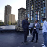 
              Jaylani Hussein, executive director of the Minnesota chapter of the Council on American-Islamic Relations, left, and Wali Dirie, executive director of the Islamic Civic Society of America Dar Al-Hijrah mosque, center, talk on the roof of Dar Al-Hijrah, where the call to prayer, or adhan, is publicly broadcast, on Thursday, May 12, 2022, in Minneapolis. (AP Photo/Jessie Wardarski)
            