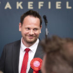 
              Labour candidate Simon Lightwood celebrates winning the Wakefield by-election, following the by-election count at Thornes Park Stadium in Wakefield, West Yorkshire Friday, June 24, 2022. The by-election was triggered by the resignation of Imran Ahmad Khan following his conviction for sexual assault. (Danny Lawson/PA via AP)
            