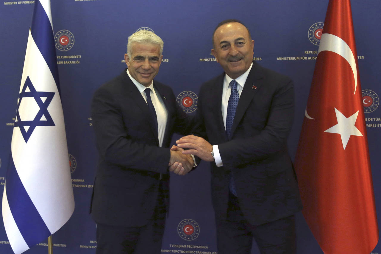 Turkish Foreign Minister Mevlut Cavusoglu, right, and Israeli Foreign Minister Yair Lapid pose for ...