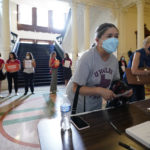 
              Women with Moms Demand Action gather outside the Texas Senate Chamber as as guests register for the second day of a hearing, Wednesday, June 22, 2022, in Austin, Texas. The hearing is in response to the recent school shooting in Uvalde, Texas, where two teachers and 19 students were killed. (AP Photo/Eric Gay)
            