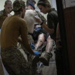 
              Paramedics treat a Ukrainian injured serviceman in the  Donetsk region, eastern Ukraine, Tuesday, June 7, 2022. (AP Photo/Bernat Armangue)
            