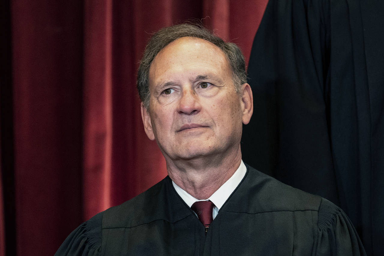 FILE - Associate Justice Samuel Alito sits during a group photo at the Supreme Court in Washington,...