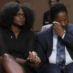 
              Raymond Whitfield, right, reacts as his brother Garnell Whitfield, Jr., of Buffalo, N.Y., not pictured, talks about their mother Ruth Whitfield who was killed in the Buffalo Tops supermarket mass shooting during a Senate Judiciary Committee hearing on domestic terrorism, Tuesday, June 7, 2022, on Capitol Hill in Washington. Zeneta Everhart, whose son Zaire Goodman, 20, was shot in the neck during the shooting and survived listens at left. (AP Photo/Jacquelyn Martin)
            