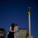 
              A couple embrace on Maidan square in Kyiv, Ukraine, Monday, June 6, 2022. (AP Photo/Natacha Pisarenko)
            