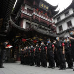 
              Security guards prepare for duty at the Yu Garden Mall, Thursday, June 2, 2022, in Shanghai. Traffic, pedestrians and joggers reappeared on the streets of Shanghai on Wednesday as China's largest city began returning to normalcy amid the easing of a strict two-month COVID-19 lockdown that has drawn unusual protests over its heavy-handed implementation. (AP Photo/Ng Han Guan)
            