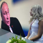 
              A participant watches as Russian President Vladimir Putin speaks at a plenary session of the St. Petersburg International Economic Forum in St.Petersburg, Russia, Friday, June 17, 2022. Putin said at Russia's showpiece investment conference Friday that the country's economy will overcome "reckless and insane" sanctions, while condemning the United States for acting like "God's own messengers on planet Earth." (AP Photo/Dmitri Lovetsky)
            