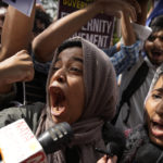 
              Muslim students shout anti-government slogans during a protest outside Uttar Pradesh house, in New Delhi, Monday, June 13, 2022. The students were protesting against persecution of Muslims and recent demolition of their houses following last week's protests against former Bharatiya Janata Party spokesperson Nupur Sharma's remark deemed derogatory to Islam's Prophet Muhammad. (AP Photo/Manish Swarup)
            