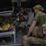 
              An injured Ukrainian servicemen is transferred to a medical facility after getting an emergency medical treatment in the  Donetsk region, eastern Ukraine, Tuesday, June 7, 2022. (AP Photo/Bernat Armangue)
            