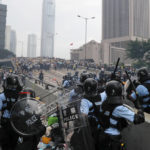
              FILE - Riot police gather face off with demonstrators near the Legislative Council in Hong Kong on June 12, 2019. When the British handed its colony Hong Kong to Beijing in 1997, it was promised 50 years of self-government and freedoms of assembly, speech and press that are not allowed Chinese on the Communist-ruled mainland. As the city of 7.4 million people marks 25 years under Beijing's rule on Friday, those promises are wearing thin. Hong Kong's honeymoon period, when it carried on much as it always had, has passed, and its future remains uncertain, determined by forces beyond its control. (AP Photo/Kin Cheung, File)
            