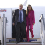 
              British Prime Minister Boris Johnson and his wife Carrie Johnson disembark from their plane as they arrive for the Commonwealth Heads of Government Meeting, in Kigali, Rwanda, Thursday, June 23, 2022. (Dan Kitwood/Pool Photo via AP)
            