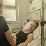 
              Andrea Prudente, 38, who suffered an incomplete miscarriage while vacationing in Malta lies in her bed at the Mater Dei Hospital in Msida, Malta, comforted by her partner Jay Weeldreyer, left, Thursday, June 23, 2022. Prudente will be airlifted to a Spanish island on Thursday for a procedure to prevent infection because Maltese law prohibits abortion under any circumstances, the woman's partner said. (Jay Weeldreyer via AP)
            
