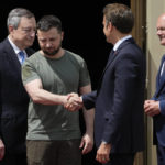 
              Ukrainian President Volodymyr Zelenskyy, second left, shake hands with French President Emmanuel Macron, as they are flanked by Italian Prime Minister Mario Draghi, left, and German Chancellor Olaf Scholz, at the Mariyinsky Palace in Kyiv, Ukraine, Thursday, June 16, 2022. French President Emmanuel Macron, left, shakes hands with Ukrainian President Volodymyr Zelenskyy at the Mariyinsky Palace in Kyiv, Ukraine, Thursday, June 16, 2022. Four European leaders, of France, Italy, Germany and Romania, made a high-profile visit to Ukraine, where they were saw the ruins of a Kyiv suburb on Thursday and denounced the brutality of a Russian invasion that has killed many civilians. (AP Photo/Natacha Pisarenko)
            