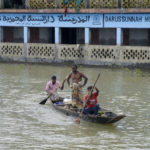 
              Flood affected people row a country boat as they head to collect their belongings from a walkway in Sylhet, Bangladesh, Wednesday, June 22, 2022. (AP Photo/Mahmud Hossain Opu)
            