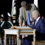 
              President Joe Biden signs a guest book after arriving as Bavarian Prime Minister Markus Soeder stands next to him at Munich International Airport in Munich, Germany, Saturday, June 25, 2022. Biden is in Germany to attend a Group of Seven summit of leaders of the world's major industrialized nations. (AP Photo/Susan Walsh)
            
