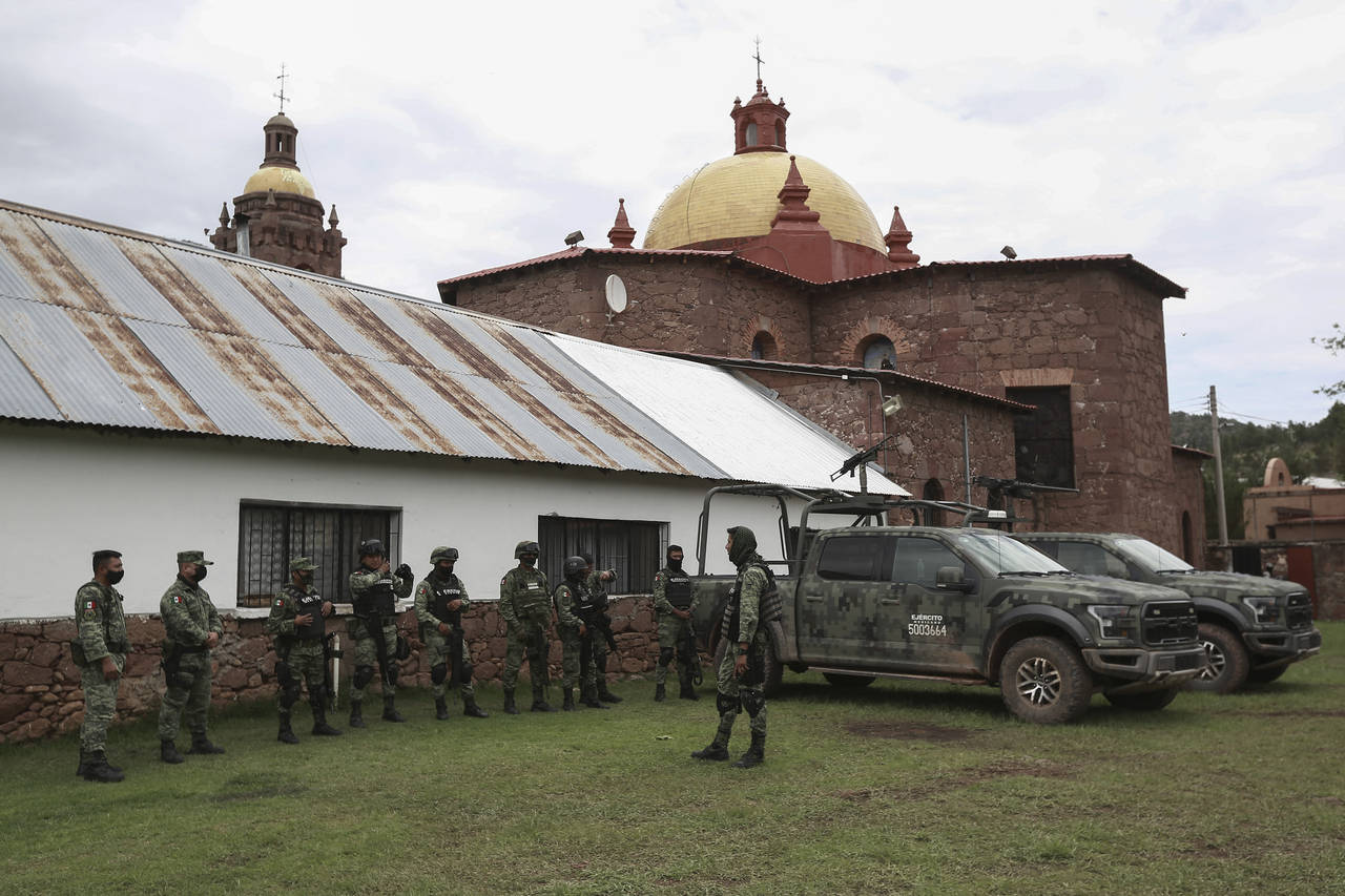 Mexican soldiers arrive to the church in Cerocahui, Mexico, Wednesday, June 22, 2022. The two elder...