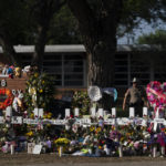 
              FILE - Flowers and candles are placed around crosses at a memorial outside Robb Elementary School to honor the victims killed in this week's school shooting in Uvalde, Texas Saturday, May 28, 2022. The gunmen in two of the nation's most recent mass shootings, including last week's massacre at the Texas elementary school, legally bought the assault weapons they used after they turned 18. That's prompting Congress and policymakers in even the reddest of states to revisit whether to raise the age limit to purchase such weapons.  (AP Photo/Jae C. Hong, File)
            