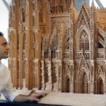 
              Fadel Alkhudr from Syria poses near the south part of his wooden model of the word heritage Cologne Cathedral on display at the Domforum in Cologne, Germany, Monday, June 20, 2022. Fadel Alkhudr, 42, a woodcarver and artist orginally from Aleppo, Syria, fled the war in his home country and arrived in the western german city of Cologne in 2015. In 2019 he started to carve the local Cologne Cathedral in his small basement - without any plans or drawings, using only cell phone photos of the cathedral as a template. (AP Photo/Martin Meissner)
            