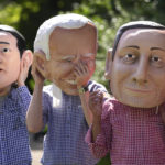 
              Activists from Oxfam wear giant heads depicting G7 leaders during a demonstration in Munich, Germany, Saturday, June 25, 2022. The G7 Summit will take place at Castle Elmau near Garmisch-Partenkirchen from June 26 through June 28, 2022. Leaders depicted from left, Japan's Prime Minister Fumio Kishida U.S. President Joe Biden and Italy's Prime Minister Mario Draghi. (AP Photo/Matthias Schrader)
            