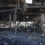 
              Ukrainian State Emergency Service firefighters work to take away debris at a shopping center burned after a rocket attack in Kremenchuk, Ukraine, Tuesday, June 28, 2022. (AP Photo/Efrem Lukatsky)
            