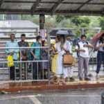 
              People wait for public transport as it rains in New Delhi Thursday, June 30, 2025. India's monsoon season runs from June to September. (AP Photo/Rajesh Kumar Singh)
            