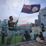 
              FILE - A protester waves Hong Kong British colony flag during continuing pro-democracy rallies in Tamar Park, Hong Kong, on Sept. 3, 2019. When the British handed its colony Hong Kong to Beijing in 1997, it was promised 50 years of self-government and freedoms of assembly, speech and press that are not allowed Chinese on the Communist-ruled mainland. As the city of 7.4 million people marks 25 years under Beijing's rule on Friday, those promises are wearing thin. Hong Kong's honeymoon period, when it carried on much as it always had, has passed, and its future remains uncertain, determined by forces beyond its control. (AP Photo/Vincent Yu, File)
            