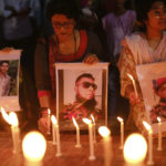 
              People light candles to pay tribute to victims of a massive fire at the BM Inland Container Depot, at Chittagong as they gather at Shahid Minar in Dhaka, Bangladesh, Monday, June 6, 2022. Authorities in Bangladesh were still struggling Monday to determine the cause of the devastating fire that killed at least 49 people, including nine firefighters, and injured more than 100 others. (AP Photo/Mahmud Hossain Opu)
            