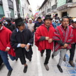 
              Indigenous leader Leonidas Iza, center right, leads a march towards downtown Quito, Ecuador, Monday, June 27, 2022. Ecuadorian President Guillermo Lasso announced a cut in gasoline prices Sunday that fell short of the reduction demanded by Indigenous leaders to end a strike that has paralyzed parts of the country for two weeks.(AP Photo/Dolores Ochoa)
            