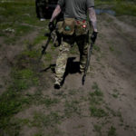 
              A civilian militia man holds a shotgun and a rifle during training at a shooting range in outskirts Kyiv, Ukraine, Tuesday, June 7, 2022. (AP Photo/Natacha Pisarenko)
            
