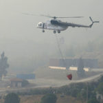 
              A water-dropping aircraft flies over the Bordubet region, near Marmaris, western Turkey, Thursday, June 23, 2022. Water-dropping aircraft from Azerbaijan and Qatar on Friday joined the fight against a wind-stoked wildfire that burned for a fourth day near a popular resort in southwestern Turkey. Turkey's forestry minister meanwhile, said the fire may be close to being contained but said the wind still posed a risk. (AP Photo)
            