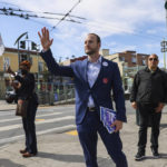 
              District Attorney Chesa Boudin waves at cars honking in support as he canvasses on 3rd Street in the Bayview neighborhood ahead of the recall on Tuesday, June 7, 2022, in San Francisco. (Gabrielle Lurie/San Francisco Chronicle via AP)
            